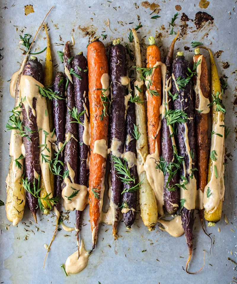 Roasted Sesame Ginger Carrots with Spicy Tahini and Carrot Greens